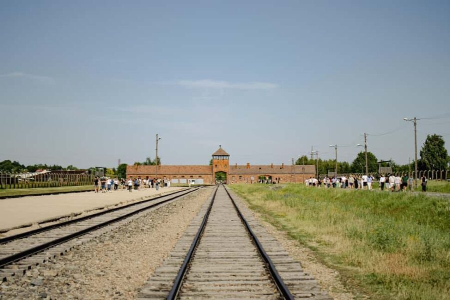 From Krakow: Auschwitz-Birkenau Guided Tour & Pickup - Auschwitz I: walking through Arbeit Macht Frei and seeing the preserved areas