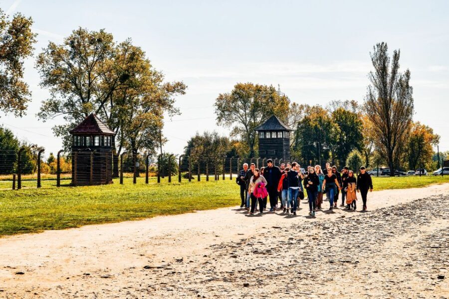 Krakow: Auschwitz-Birkenau Live Guided Tour & Hotel Pickup - Entering Auschwitz I: the gate, Zyklon B, and Block 11